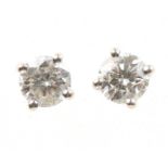 A pair of diamond stud earrings The brilliant cut diamonds within four claw settings, stamped 750,