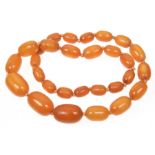 An amber style bead necklace Designed as twenty nine graduated oval amber style beads, length