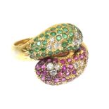A vari gem snake ring The circular shaped emerald and ruby crossover snakes, with brilliant cut
