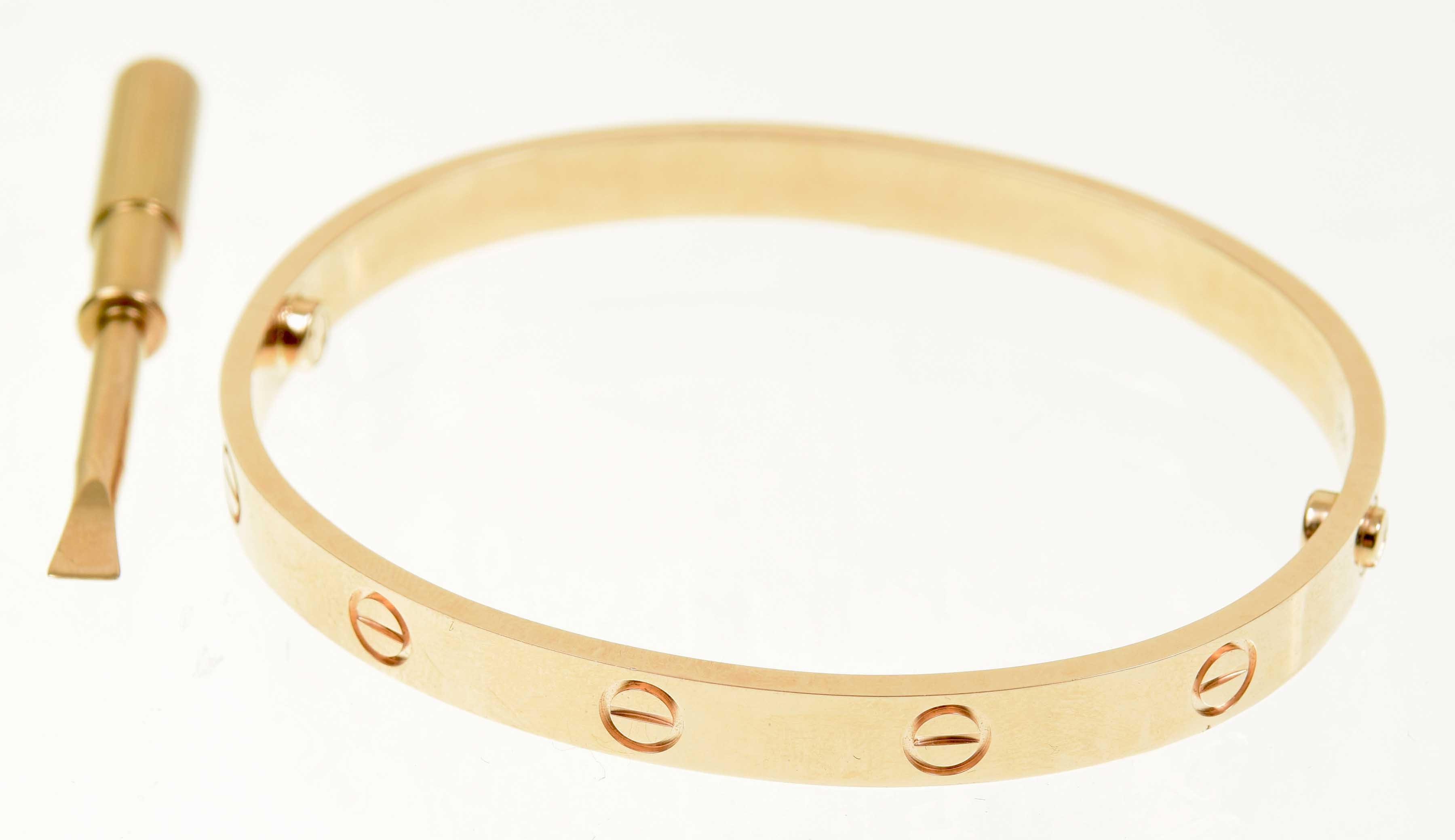 A Cartier 'Love' bangle Designed as a series of screw head motifs with screw fitting, signed and