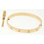 A Cartier 'Love' bangle Designed as a series of screw head motifs with screw fitting, signed and