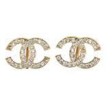 A pair of Chanel clip earrings Each designed as a colourless paste entwined C logo, signed Chanel to