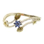 A diamond and paste bangle Of floral design, the blue paste flower with brilliant cut diamond line