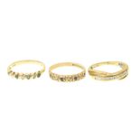 Three 9ct gold gem-set band rings To include a diamond band ring, an emerald and diamond band