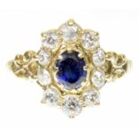 An 18ct gold sapphire and diamond dress ring The oval shaped sapphire within a vari-size old cut