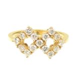 An 18ct gold diamond dress ring Designed as a pair of brilliant cut diamond kites to the tapered