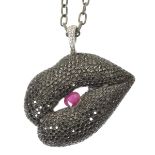 An 18ct gold Gavello diamond and ruby pendant The pavé set black diamond lips encasing an oval