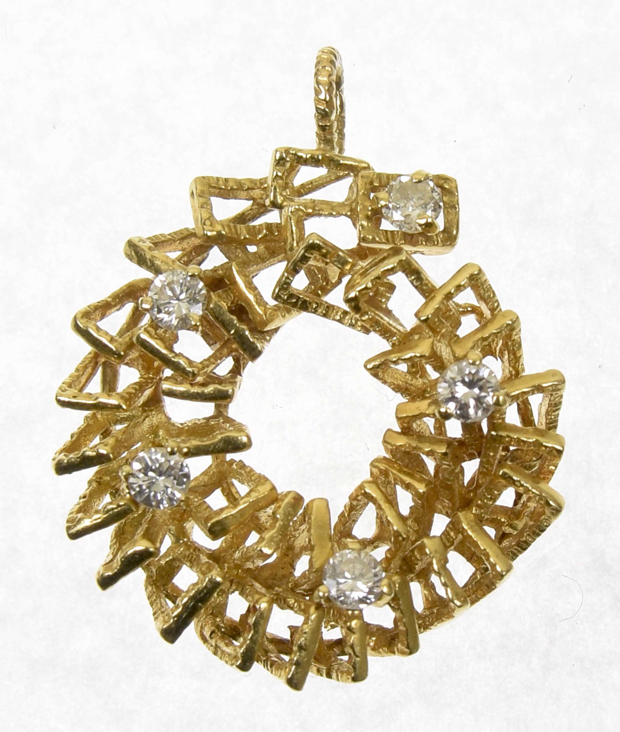 A 1970s diamond pendant The textured openwork wreath with brilliant cut diamond accents, estimated