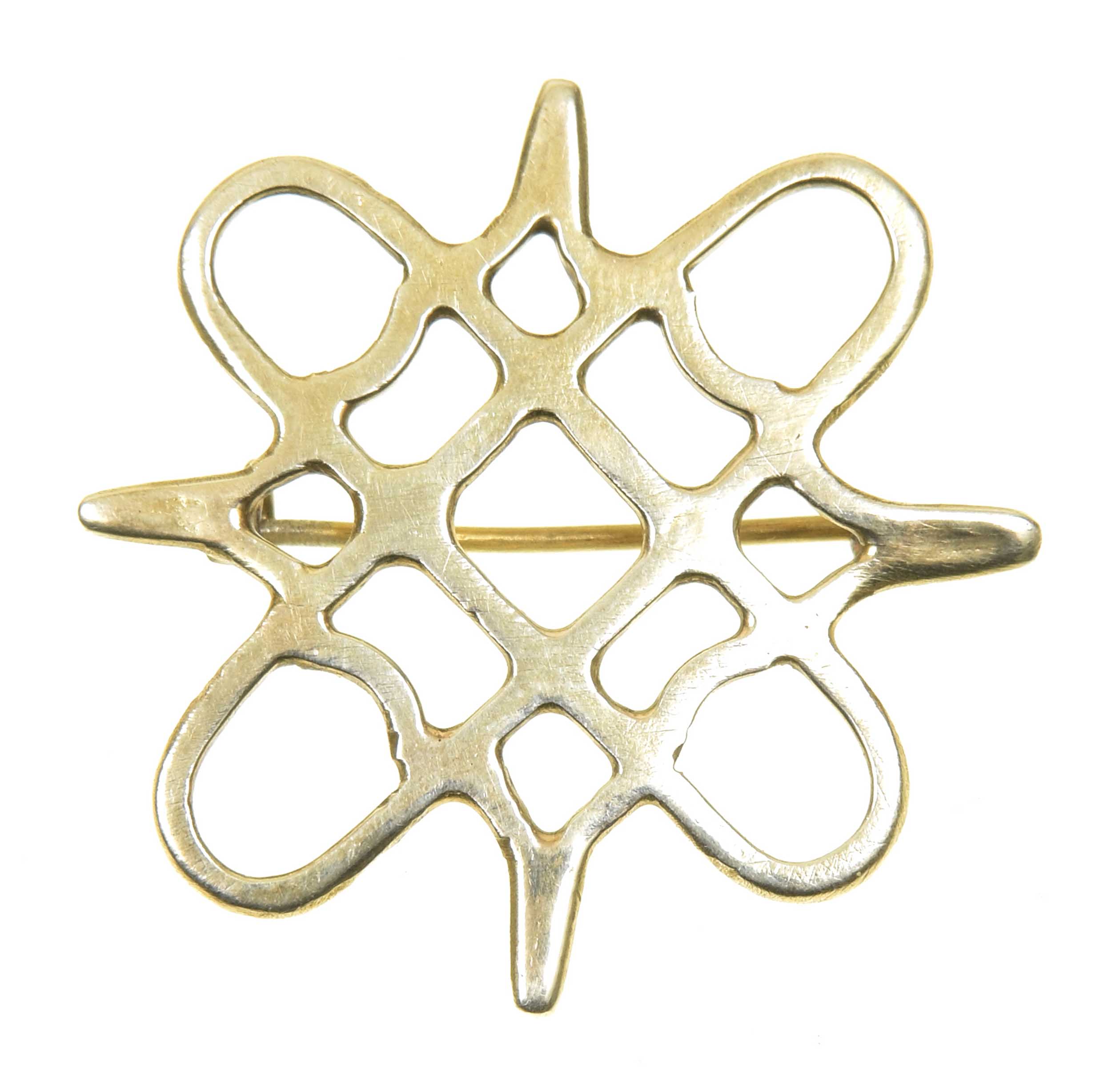 A 1980s 9ct gold brooch Of openwork design, the asymmetric grid within a looped and pointed