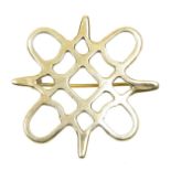 A 1980s 9ct gold brooch Of openwork design, the asymmetric grid within a looped and pointed