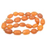 A string of amber style beads The graduated amber style beads with a spring clasp, length 45.5cm,