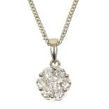 An 18ct gold diamond pendant The brilliant cut diamond within a similarly cut diamond floral
