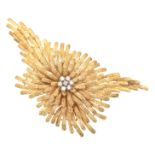 A diamond spray brooch Of asymmetric design, the single cut diamond floral cluster within a textured