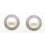 A pair of cultured pearl and diamond earrings Each designed as a cultured pearl, within a
