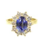 A tanzanite and diamond cluster ring The oval shaped tanzanite within a brilliant cut diamond