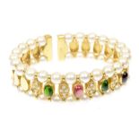 A tourmaline diamond and cultured pearl bangle Of sprung design, the series of pink and green oval
