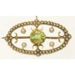 An early 20th Century peridot and split pearl brooch The rectangular shaped peridot within an oval
