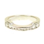 A platinum diamond band ring The graduated brilliant cut diamond line within the shaped band,
