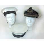 A British Naval Officers peaked cap, mid 20th Century Two Naval rating caps with tallies for HMS