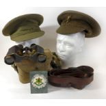 A pair of War Department binoculars, case dated 1943 A Welsh Guards other ranks cap, further cap,