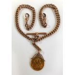 A George V gold sovereign and 9ct gold Albert chain Gold sovereign London Mint dated 1915, on