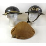 A WWII period black painted Wardens helmet The helmet with painted letters RP/W, mid 20th Century,
