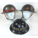 Three WWII period painted metal helmets To include two fire service helmets no. 26 and 40, black