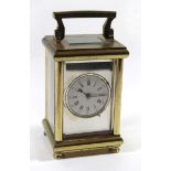 A 20th Century brass framed French carriage clock The silvered face with central white enamel dial