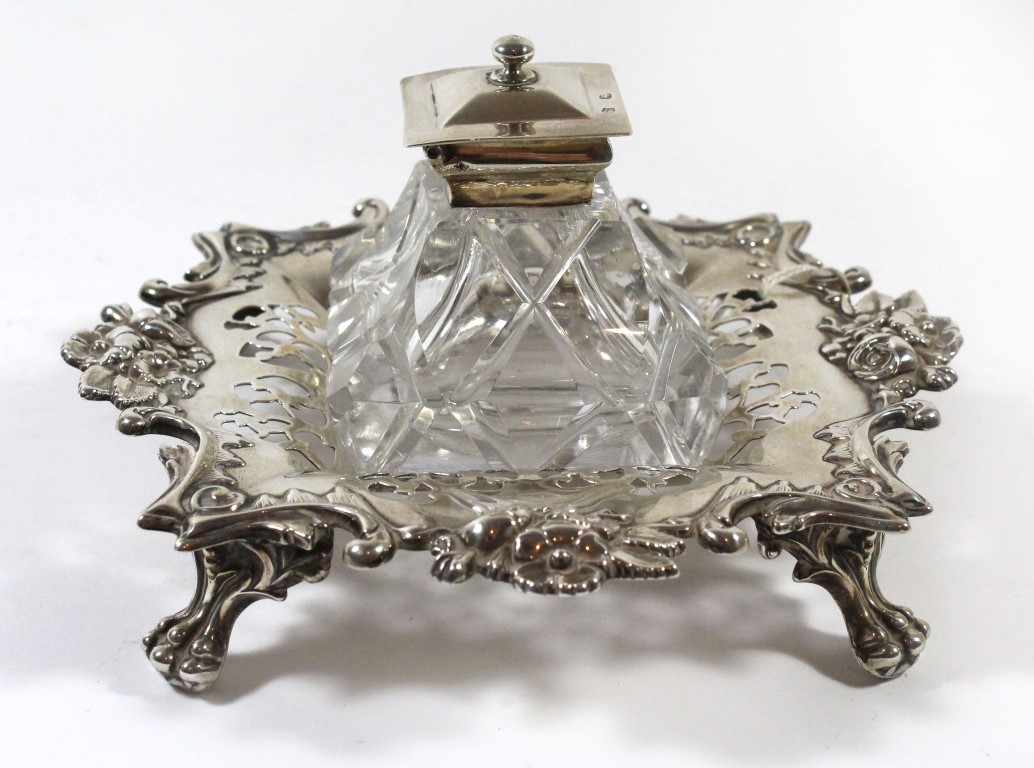 A Victorian silver desk inkstand Of pierced and floral decorated form, raised on four short legs