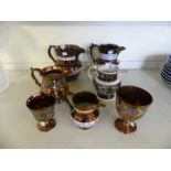 A collection of 19th Century copper lustre ware comprising five jugs and two goblets (7)