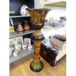 A brown glazed urn formed jardiniere and stand (af)