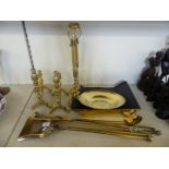 A mixed lot of various brass fire tools, fire dogs, a pair of barley twist candlesticks and other