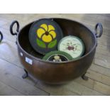 A copper and iron three footed log bucket together with decorative plates