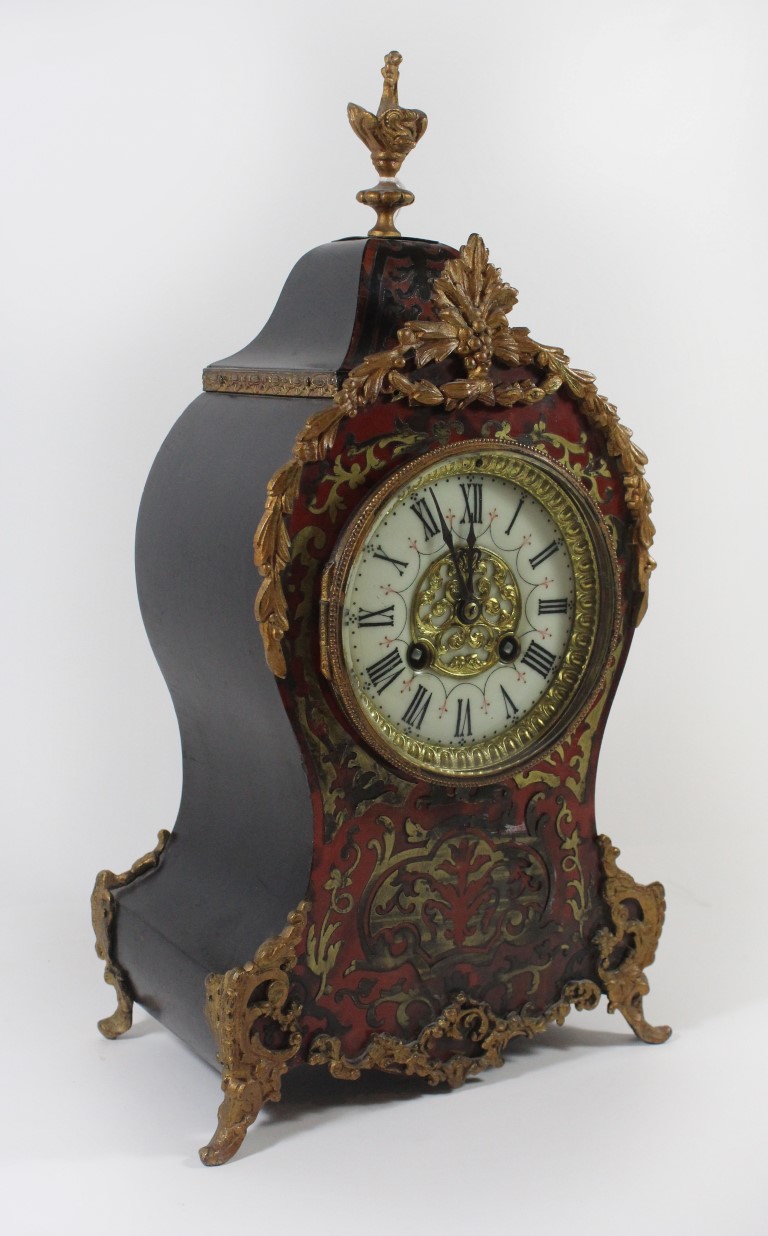 A 19th Century French Boulle work mantle clock Having circular enamelled dial with Roman numerals