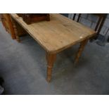 A Victorian style pine slab top kitchen table.