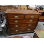 A George IV oak chest of two short and three long drawers with quarter cluster columns.
