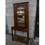 An early 20th Century oak arts and crafts mirror back hall stand