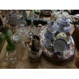 A collection of glassware Including two glass decanters with etched design, a glass jug with