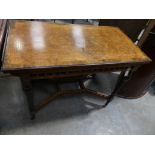 A Victorian bur walnut folding games tables The rectangular folding top inlaid with stringing