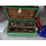 A collection of tools To a pine chest, to include various hammers and woodworking tools.