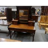 A Victorian walnut dressing table, raised upon ring turned and ring incised supports.