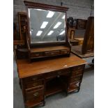 A late Victorian walnut dressing table, the rectangular beveled mirror above three small drawers,