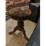 A Victorian walnut revolving piano stool with a spirally lobed shaft.