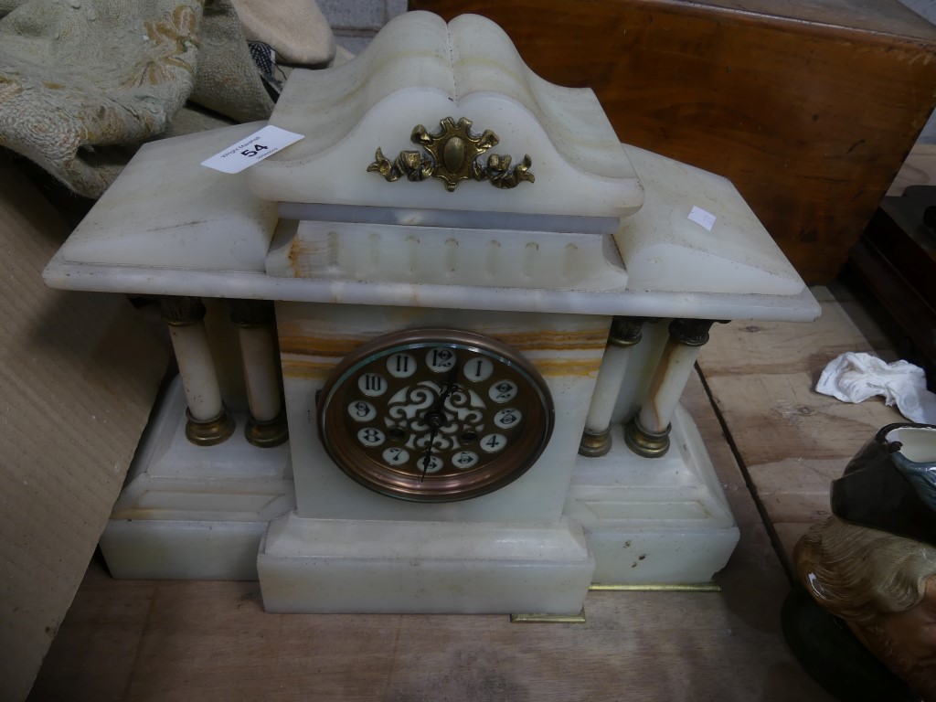 A Victorian alabaster architectural mantle clock with a gilt metal dial and two train movement.