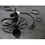 A penny farthing wrought iron garden planter.