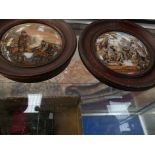 A pair of 19th century Staffordshire pot lids within oak frames To include one depicting villagers
