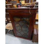 A 19th Century glazed mahogany hanging corner cupboard Having a moulded Greek key pattern frieze