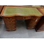 A good quality Queen Anne style serpentine walnut desk The serpentine top inset with a green leather