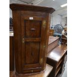 A Reproduction George III style oak and mahogany crossbanded hanging corner cupboard.