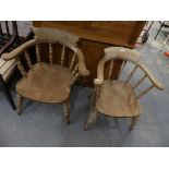 A pair of Victorian smokers bow elbow chairs